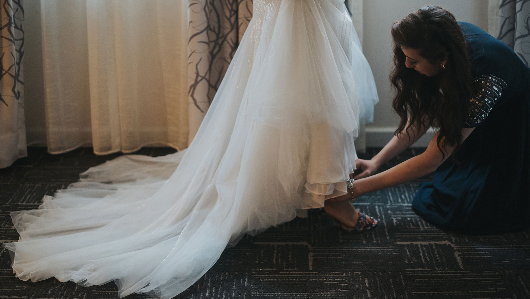 bridesmaids helping bride get ready