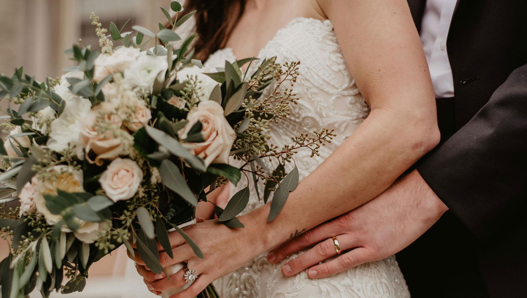 kimpton portland hotel vintage wedding - groom standing behind bride with his hands on her waist, bride is holding a bouquet