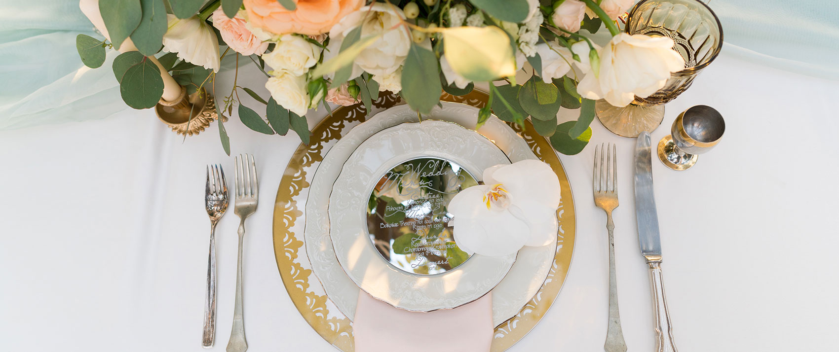 table set with wedding flowers and champagne glasses