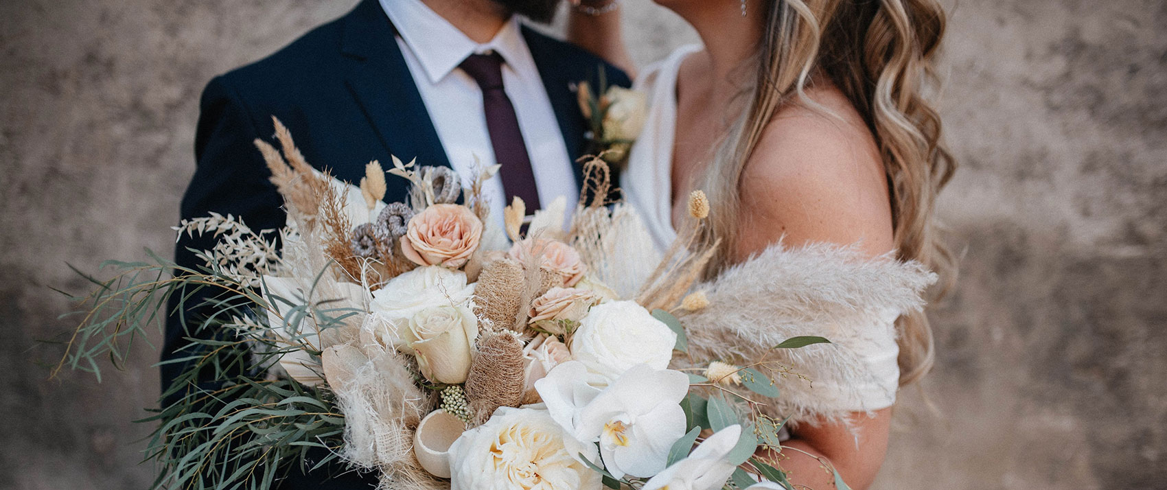 Kimpton Hotel Vintage Portland wedding - Bride and Groom hugging while holding a large bouquet